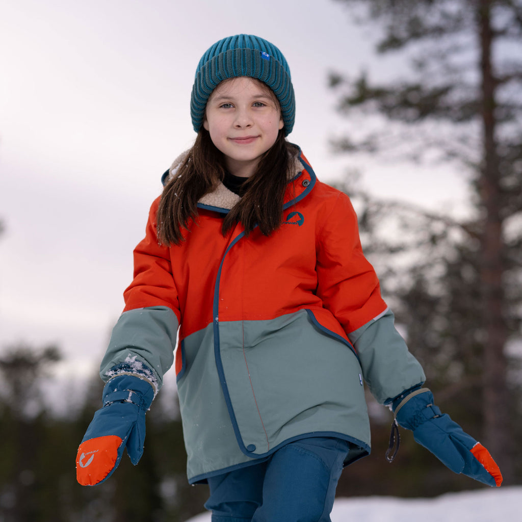 Winter mittens on a child: blue mittens with orange details