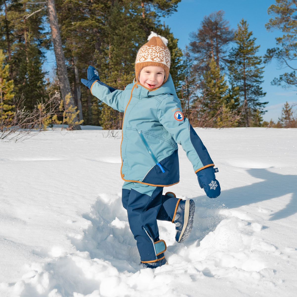 Light blue children's winter mittens with snowflake pattern and knitted cuffs