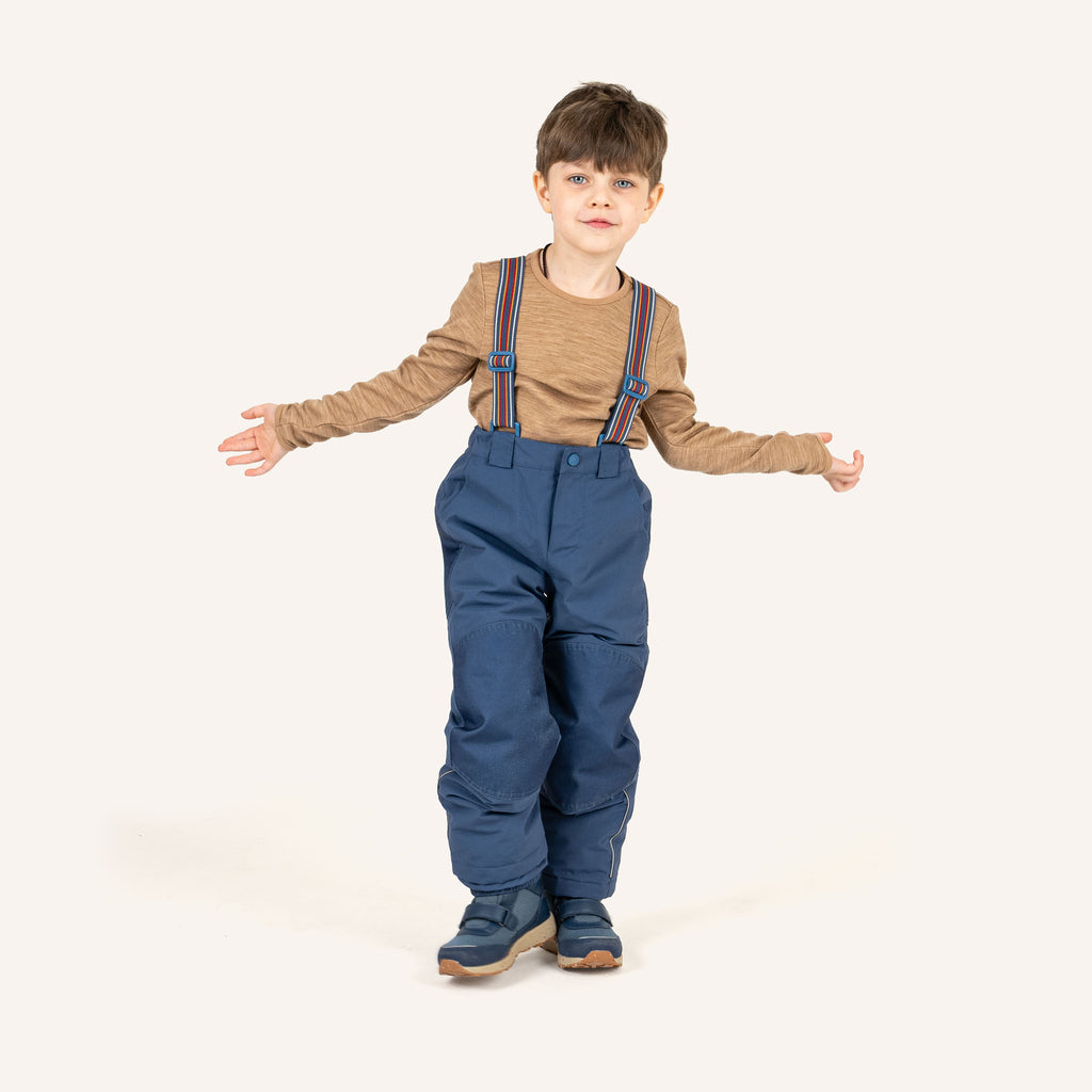 Dark blue children's overalls worn by a child, with colorful straps and leg cuffs