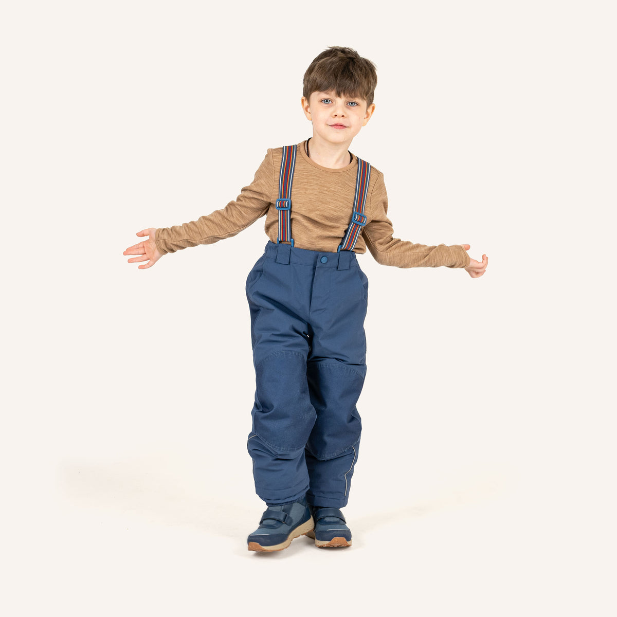 Dark blue children's overalls worn by a child, with colorful straps and leg cuffs