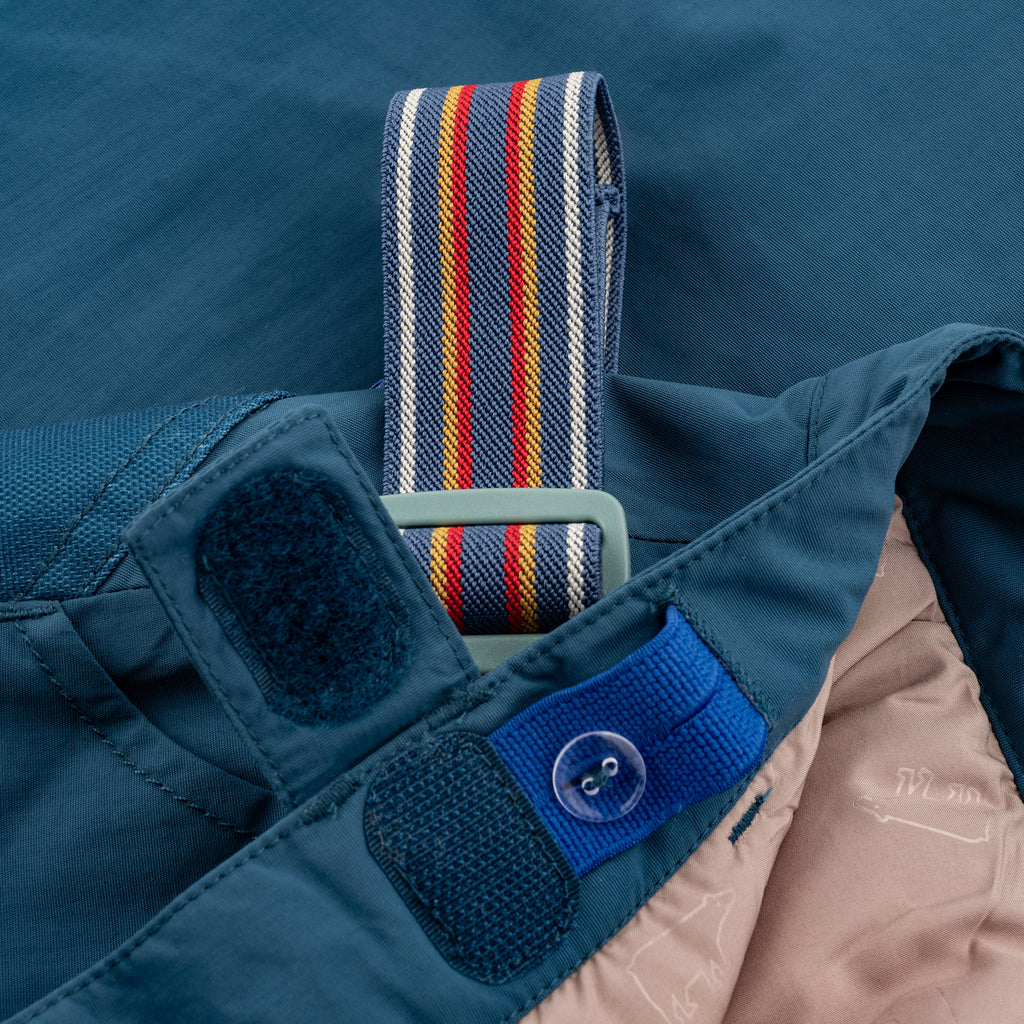 Petrol-colored bib overalls with button closure and wide straps